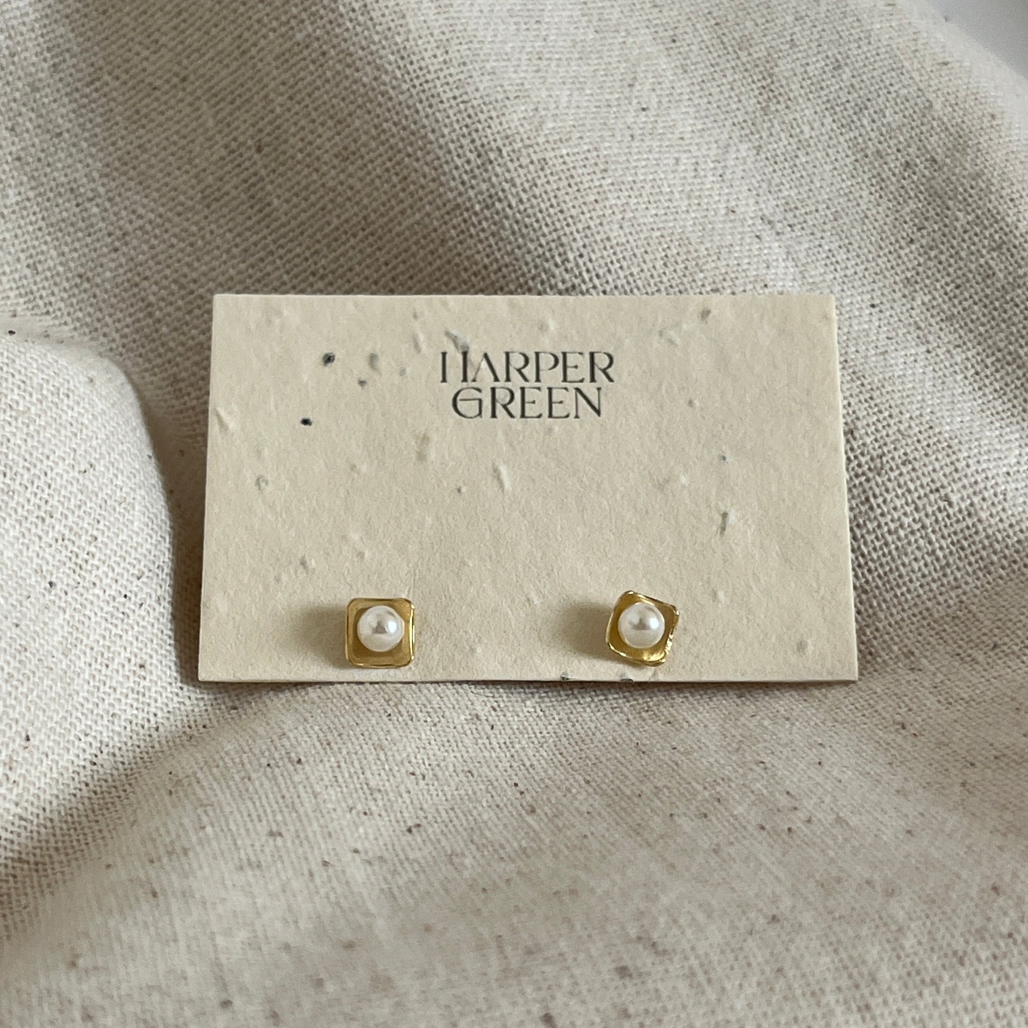 pearl stud earrings on paper. 