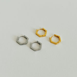 Gold and silver hexagon hoop earrings on white background.