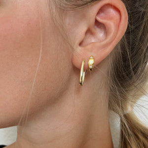 Celeste diamond hoop earring in gold on a model. 