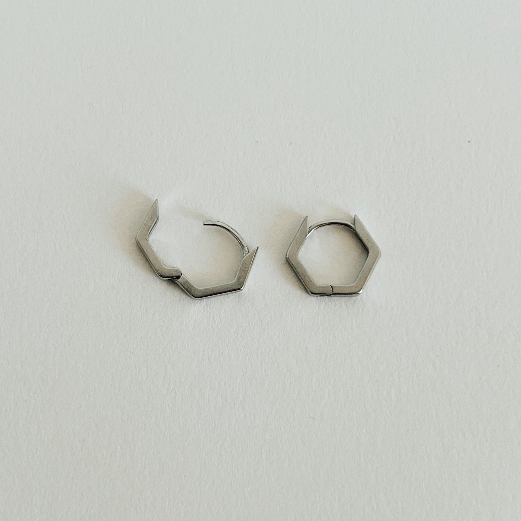 Zoey hexagon hoops in silver with clasp open.