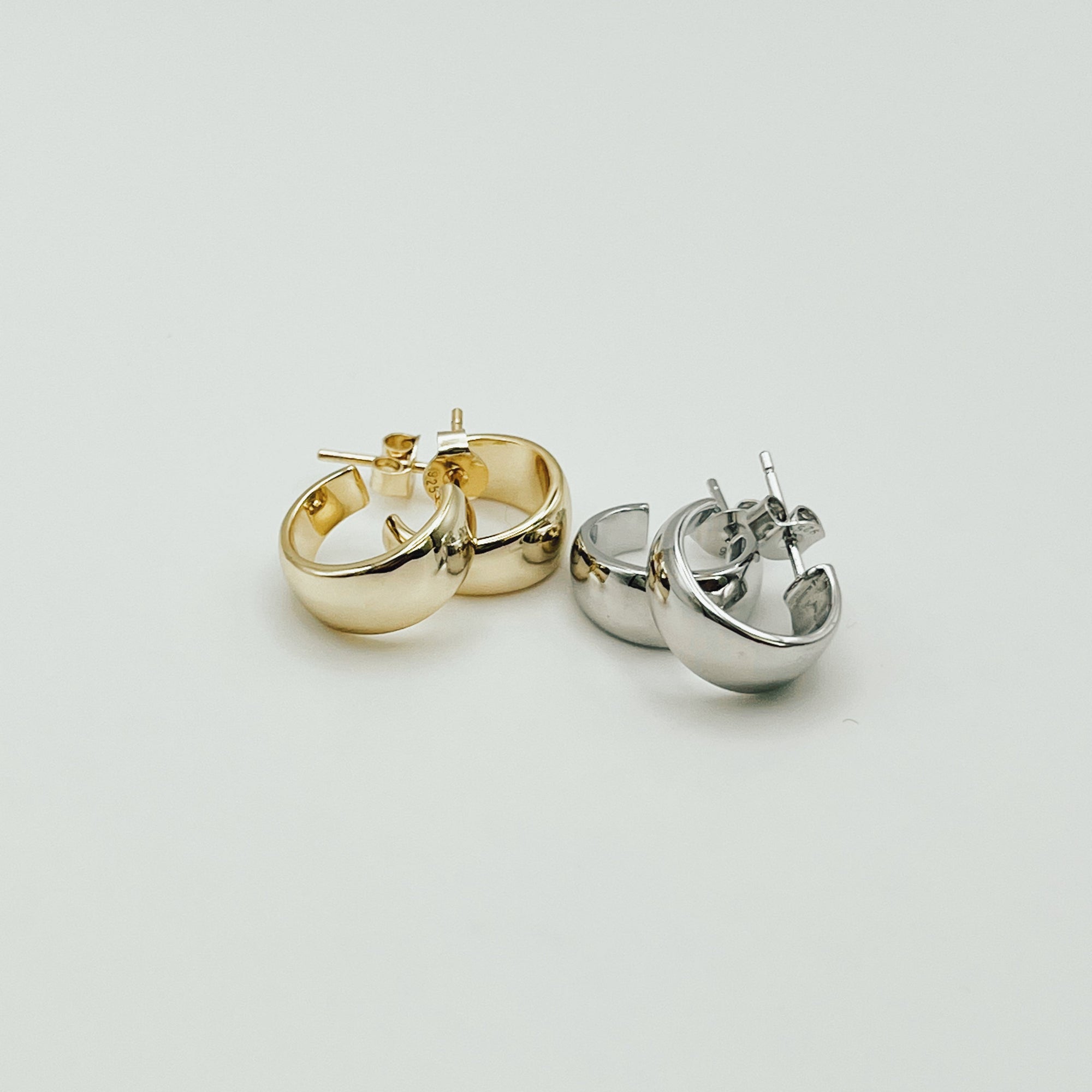 lemmie wide hoop earrings in gold and silver. 