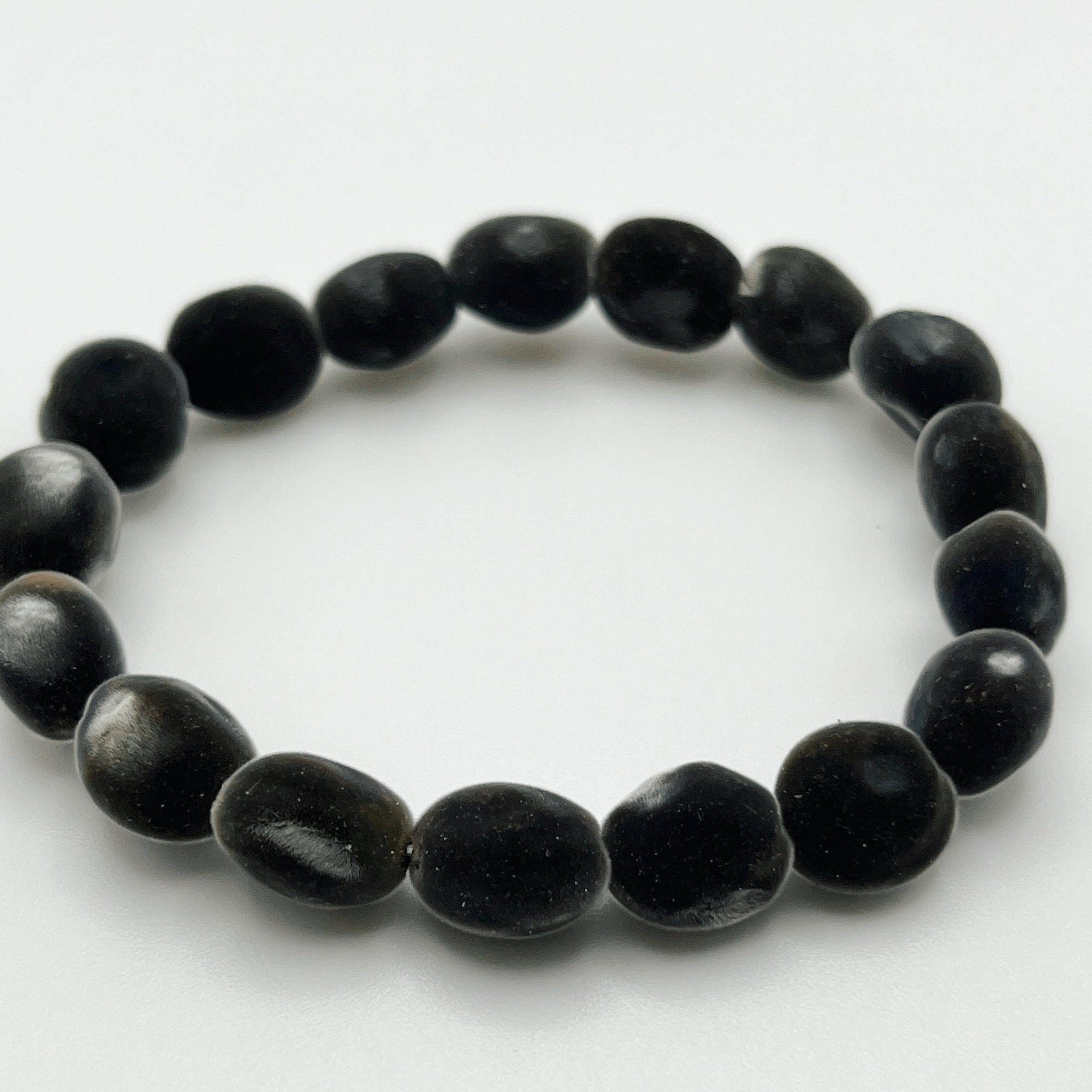 velvet Mgambo seed bracelet on white background. 