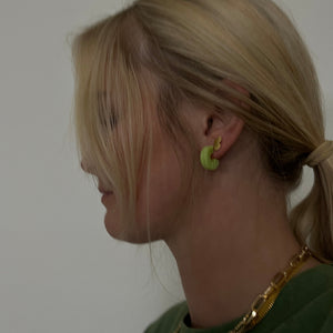 jude toroise shell hoop earrings on model. 