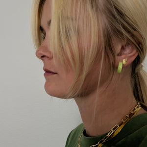 green hoop earrings shown on model. 