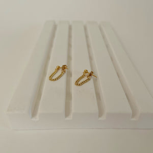 gold chain earrings on display.